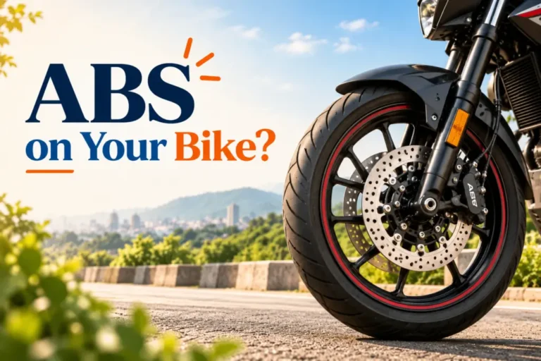 Motorcycle front wheel with ABS disc brakes on a scenic road, illustrating the importance of ABS for bike safety.